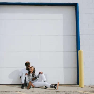 African american couple sitting outside and laughing at fun relationship questions