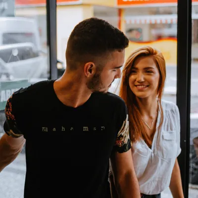 man leading woman out of a cafe to initiate sex