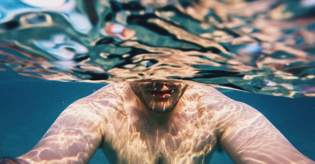 man swimming representing navigating a high sex drive