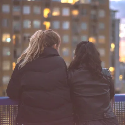 lesbian couple standing together looking at a view after a successful opening date